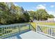 Enjoy outdoor living on this spacious deck overlooking a lush, green backyard surrounded by mature trees at 1058 Canada Dr, Dallas, NC 28034