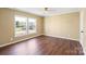 Bedroom with ceiling fan, hardwood flooring and a large window view at 1058 Canada Dr, Dallas, NC 28034