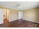 Bedroom featuring hardwood floors, neutral paint, and an adjoining bathroom at 1058 Canada Dr, Dallas, NC 28034
