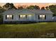 Charming home with well-manicured lawn and a cozy front porch at 1058 Canada Dr, Dallas, NC 28034
