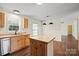 Kitchen with hardwood floors, wooden cabinets, stainless steel dishwasher, and center island at 1058 Canada Dr, Dallas, NC 28034