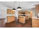Well-lit kitchen with wooden cabinets, island, modern appliances, and hardwood floors at 1058 Canada Dr, Dallas, NC 28034