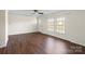 Spacious living room with hardwood floors, a ceiling fan, and natural light from large windows at 1058 Canada Dr, Dallas, NC 28034