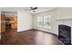 Spacious living room featuring hardwood floors, fireplace, and view of the kitchen at 1058 Canada Dr, Dallas, NC 28034