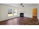 Bright living room featuring hardwood floors, a fireplace, and large windows for natural light at 1058 Canada Dr, Dallas, NC 28034