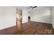Open-concept living room with hardwood floors and a view of the dining area and fireplace at 1058 Canada Dr, Dallas, NC 28034