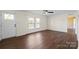 Bright living room featuring wood-look flooring, natural light, and a ceiling fan at 1058 Canada Dr, Dallas, NC 28034
