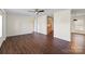 Living room with hardwood floors, a ceiling fan, and doorways leading to other parts of the home at 1058 Canada Dr, Dallas, NC 28034