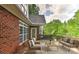 Relax on the wooden back deck featuring brick exterior, wood railing, and comfortable cushioned outdoor seating at 1090 Heather Glen Dr, Matthews, NC 28104