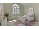 Bright bedroom with a large window, soft carpet, and light neutral walls for a calm and relaxing space at 1090 Heather Glen Dr, Matthews, NC 28104
