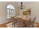 Elegant dining room features a large arched window, stylish chandelier, and ample seating for formal gatherings at 1090 Heather Glen Dr, Matthews, NC 28104
