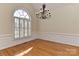 Bright dining room with a large window, hardwood floors, and classic trim, creating a serene atmosphere at 1090 Heather Glen Dr, Matthews, NC 28104