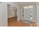 Bright foyer with hardwood floors offers a glimpse into the adjacent living area, creating a welcoming ambiance at 1090 Heather Glen Dr, Matthews, NC 28104