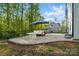 Backyard patio with stylish outdoor furniture under a large umbrella, ideal for relaxing or entertaining at 11040 E Lake Rd, Charlotte, NC 28215