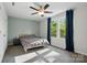 Bright bedroom with large windows and a ceiling fan, creating a comfortable and inviting atmosphere at 11040 E Lake Rd, Charlotte, NC 28215