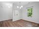 Bright dining room featuring hardwood floors, a window, and an open layout at 11040 E Lake Rd, Charlotte, NC 28215