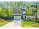 Charming two-story home with a stone-accented garage, concrete driveway and landscaped front yard at 11040 E Lake Rd, Charlotte, NC 28215