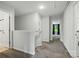 Well-lit upstairs hallway featuring neutral walls, carpet flooring, and access to several rooms at 11040 E Lake Rd, Charlotte, NC 28215