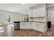 Modern kitchen with stainless steel appliances, granite counters, and white cabinetry at 11040 E Lake Rd, Charlotte, NC 28215