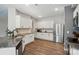 Spacious kitchen featuring white cabinets, granite countertops and stainless steel appliances at 11040 E Lake Rd, Charlotte, NC 28215