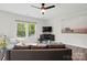 Bright living room featuring modern furnishings, a ceiling fan, and a lovely view of the outdoors at 11040 E Lake Rd, Charlotte, NC 28215
