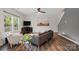 Cozy living room with a ceiling fan, hardwood floors, neutral paint, and ample seating at 11040 E Lake Rd, Charlotte, NC 28215