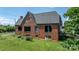 Rear view of brick home, showing the large windows and landscaping at 115 12Th Sw St, Hickory, NC 28602