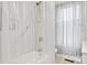 Bright bathroom features a shower with a shower curtain, grab bar and tiled walls at 115 12Th Sw St, Hickory, NC 28602