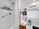 Bright bathroom features a shower with a shower curtain, grab bar, and tiled walls at 115 12Th Sw St, Hickory, NC 28602