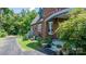 Brick home exterior with a glimpse of the lush garden and inviting outdoor space at 115 12Th Sw St, Hickory, NC 28602