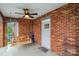 Cozy front porch featuring brick walls, a porch swing, and a ceiling fan at 115 12Th Sw St, Hickory, NC 28602