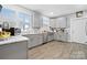 Bright kitchen with stainless steel appliances, gray cabinets, light countertops, and wood-look flooring at 115 12Th Sw St, Hickory, NC 28602