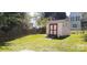 Backyard features a charming shed with red doors, surrounded by a well-maintained lawn and a wooden fence at 119 W Maranta Rd, Mooresville, NC 28117