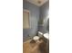 Cozy bathroom with a window, toilet, pedestal sink, tile floor, and a decorative shelf at 119 W Maranta Rd, Mooresville, NC 28117