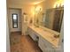 Bathroom with a double sink vanity, large mirror, and tiled flooring at 119 W Maranta Rd, Mooresville, NC 28117