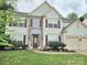 Charming two-story home with stone accents, red shutters and a well-manicured lawn at 119 W Maranta Rd, Mooresville, NC 28117