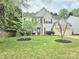 Inviting home with a well maintained lawn and landscaping with decorative trees at 119 W Maranta Rd, Mooresville, NC 28117