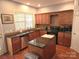Kitchen with wood cabinets, stainless steel appliances, granite countertops, and a center island at 119 W Maranta Rd, Mooresville, NC 28117