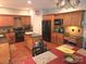 Open kitchen with wood cabinets, black appliances, granite countertops, and an island with seating at 119 W Maranta Rd, Mooresville, NC 28117