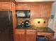 Close-up of kitchen cabinets, black appliances, granite countertop and backsplash at 119 W Maranta Rd, Mooresville, NC 28117