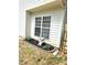 Charming garden bed with fresh mulch, vibrant greenery, and a whimsical statue add character to the home's exterior at 119 W Maranta Rd, Mooresville, NC 28117