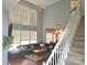 Spacious living room with a high ceiling, large windows and a gray sectional sofa at 119 W Maranta Rd, Mooresville, NC 28117