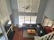 Elevated view of the living room with tall windows, fireplace, and sectional sofa open to kitchen and dining at 119 W Maranta Rd, Mooresville, NC 28117