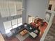 Aerial view of living room with tall windows, fireplace, and large sectional, open to kitchen and dining at 119 W Maranta Rd, Mooresville, NC 28117