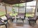 Relaxing screened porch features a ceiling fan, comfortable seating and view of the backyard at 119 W Maranta Rd, Mooresville, NC 28117