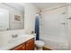 This bathroom offers a bathtub-shower combination with cherry cabinets at 1213 Salvadore Ct, Gastonia, NC 28052