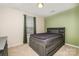 This bedroom offers a platform bed and neutral carpet and walls at 1213 Salvadore Ct, Gastonia, NC 28052
