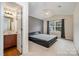 Vaulted ceiling bedroom with a full bathroom and black bed frame at 1213 Salvadore Ct, Gastonia, NC 28052