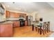 This kitchen offers wood cabinets, stainless steel appliances, and a glass-top dining table at 1213 Salvadore Ct, Gastonia, NC 28052