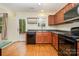 This is a kitchen that offers wood cabinets and stainless steel appliances, with outside access at 1213 Salvadore Ct, Gastonia, NC 28052